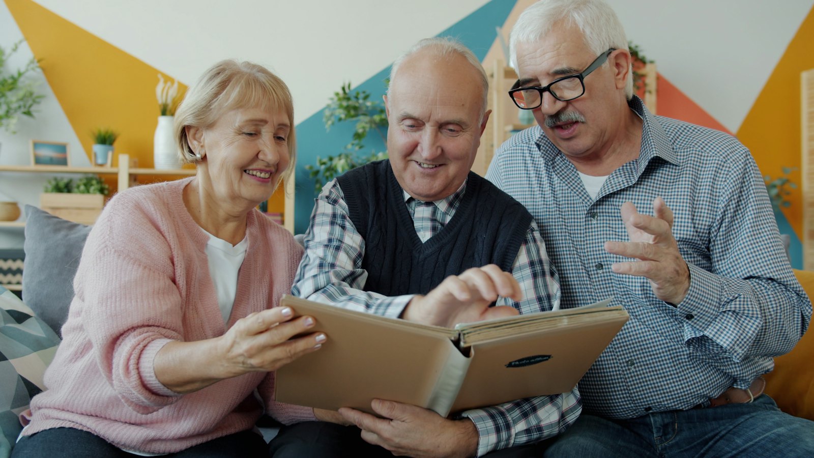 Two people looking through a photo album together.