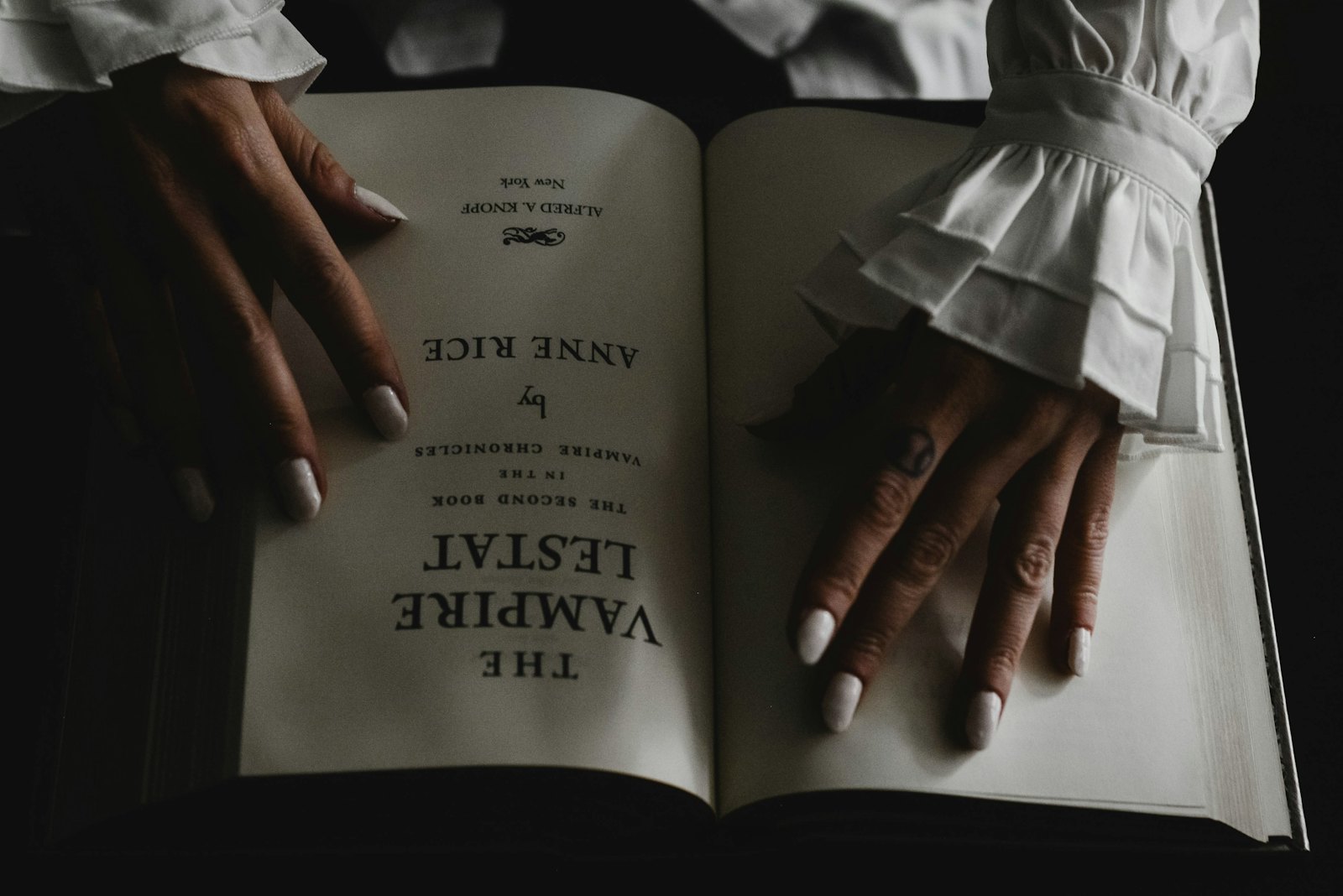 Hands holding an open book.