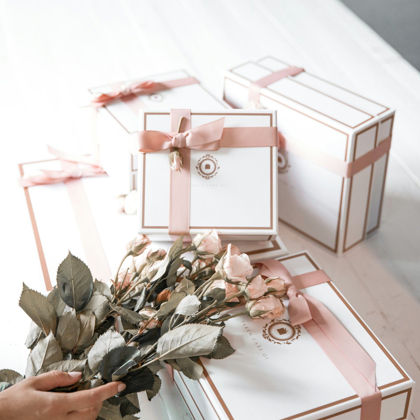 Elegant gift boxes tied with ribbon, with a card on top.