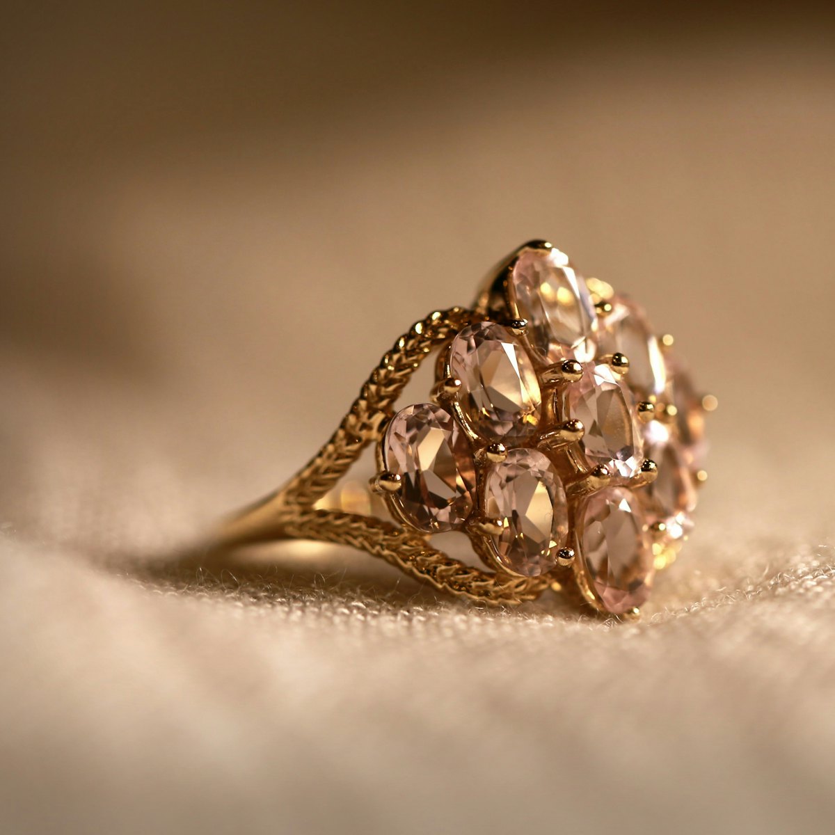 An antique gold ring resting on soft fabric.