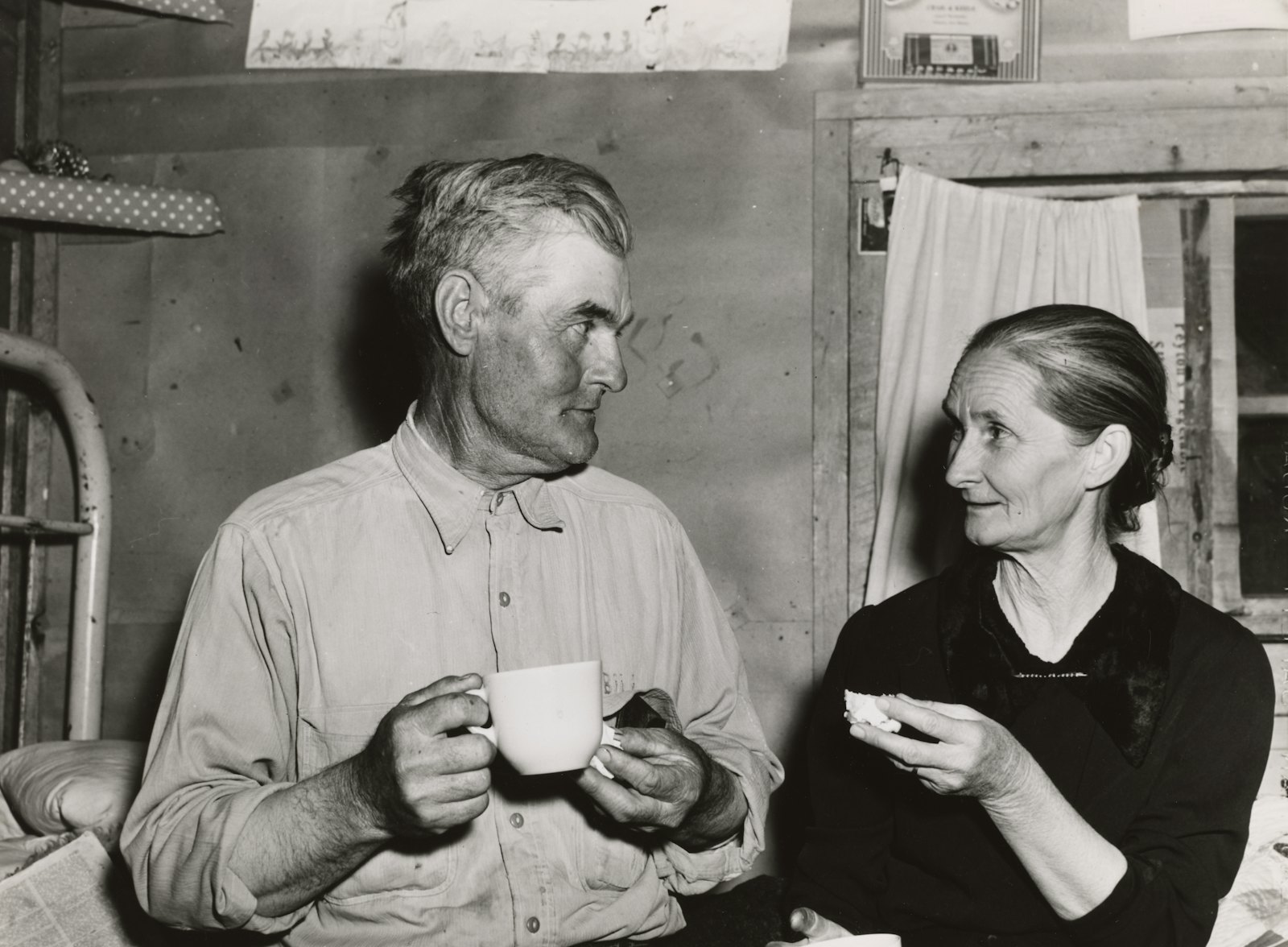 Two people sitting together over cups of tea, deep in conversation.